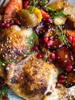 Spiced Chicken Thighs with garlicky tahini yogurt & pomegranate glazed carrots on a plate